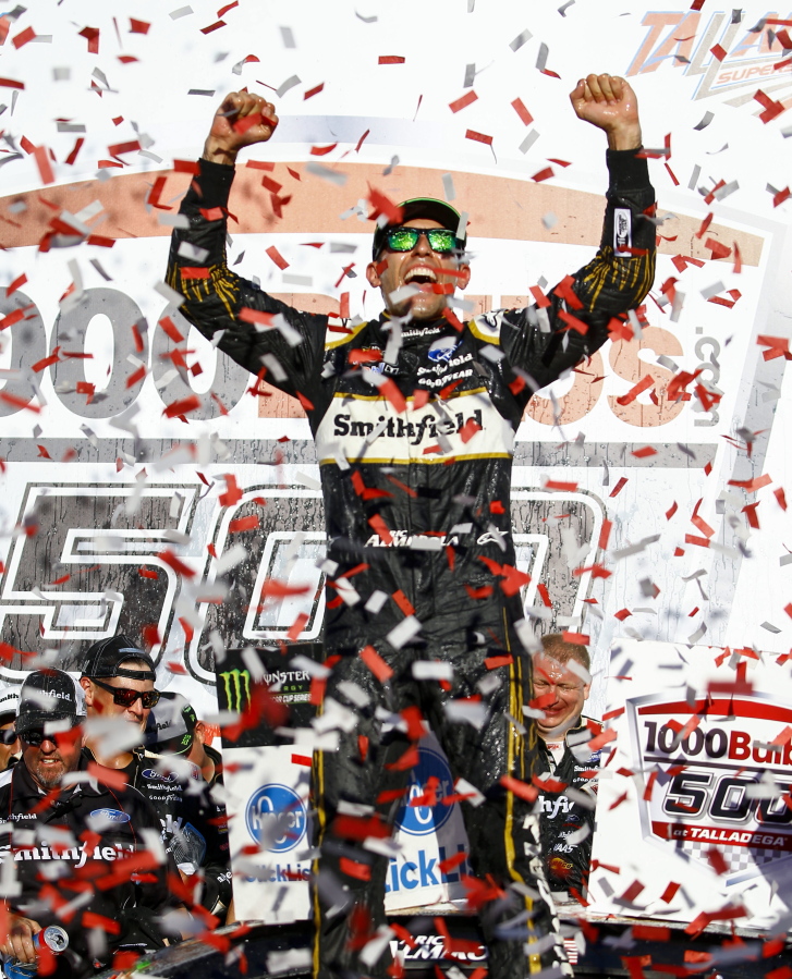 Aric Almirola celebrates in Victory Lane after winning the 1000Bulbs.com 500 NASCAR Cup Series auto race at Talladega Superspeedway, Sunday, Oct. 14, 2018, in Talladega, Ala.