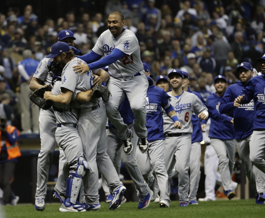 The Los Angeles Dodgers celebrate after Game 7 of the National League Championship Series baseball game Saturday, Oct. 20, 2018, in Milwaukee. The Dodgers won 5-1 to win the series.