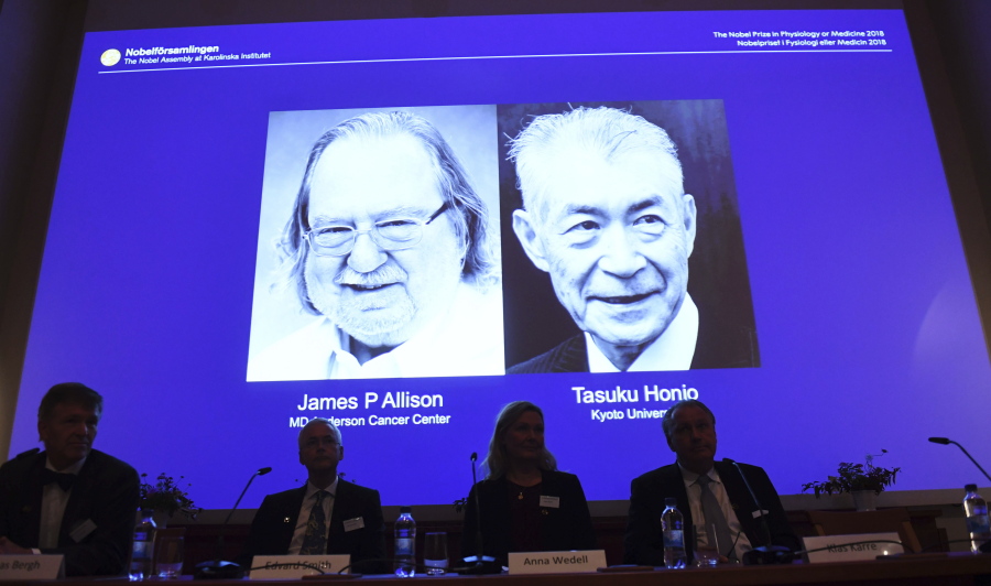 The Nobel prize laureate in medicine or physiology 2018 is shown on the screen James P Allison, left, and Tasuku Honjo, during the presentation at the Karolinska Institute in Stockholm, Sweden, Monday Oct. 1, 2018. The citation for this year’s Nobel Prize in Medicine says the two honorees developed therapies for treating cancer.