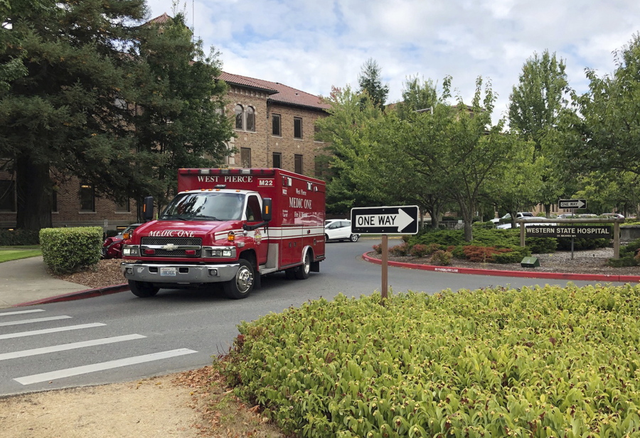 An ambulance leaves Western State Hospital in Lakewood, Wash. A patient at Washington state’s largest psychiatric hospital vaulted over the nurse’s station, knocked a nurse to the floor, choked her and bit part of her ear off. The Sunday, Sept 30, 2018, assault is the latest in a series of attacks on health care workers at Western State Hospital.