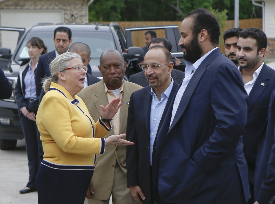 In this April 7, 2018, file photo, Saudi Crown Prince Mohammed bin Salman, right, is seen with his entourage as he tours a flood-damaged area in Houston, Texas. The man in the photo, rear second left, is allegedly the same individual in images that a pro-government Turkish newspaper published who was seen on surveillance video walking into the Saudi Consulate in Istanbul before writer Jamal Khashoggi vanished there.