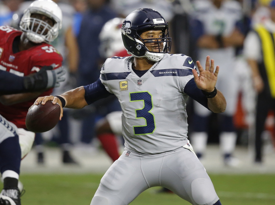 In the last four games, Seattle Seahawks quarterback Russell Wilson (3) is completing 67 percent of his passes while attempting significantly fewer throws, has a passer rating of 116.0 and has been sacked seven times. (AP Photo/Ross D.