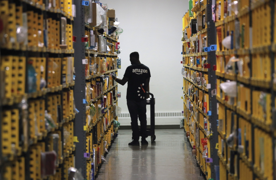 An employee of Amazon PrimeNow stacks shelves at a distribution hub in December 2016 in New York.