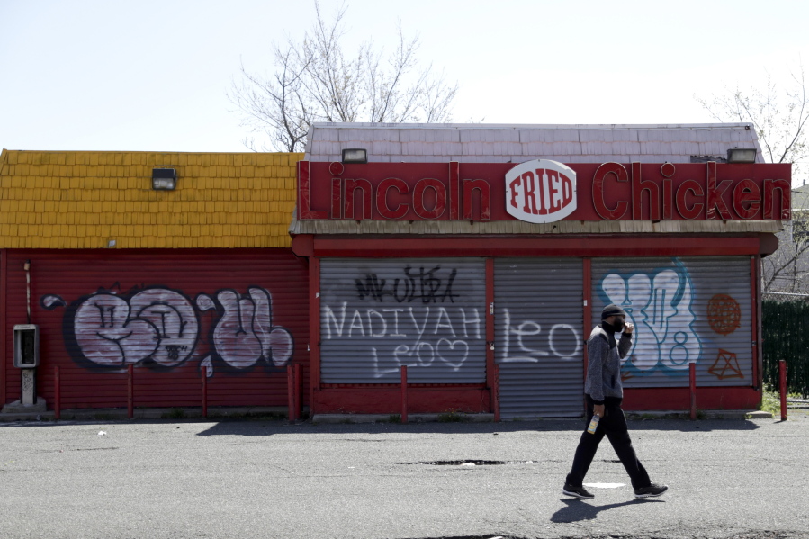 In this April 26, 2018, photo a man walks by a closed restaurant along Bergen Street in a so-called “opportunity zone” in Newark, N.J. The Trump administration on Friday, Oct. 19, proposed rules for investors in a new program that it says could have a big impact on economically depressed areas around the country. About 8,700 of the opportunity zones have been set up in all 50 states and to lure investors and developers with tax breaks.