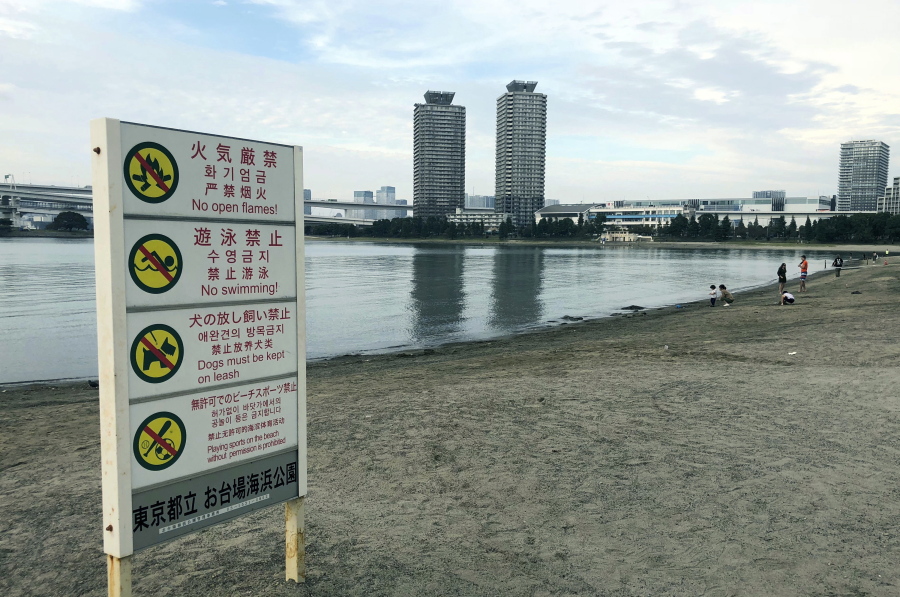 A view of the beach at Odaiba Marine Park in Tokyo with a “no swimming” sign displayed. Tokyo 2020 Olympic organizers say a system of layered screens will be used to keep bacteria levels within “agreed limits” for triathlon and marathon swimming in heavily trafficked Tokyo bay.
