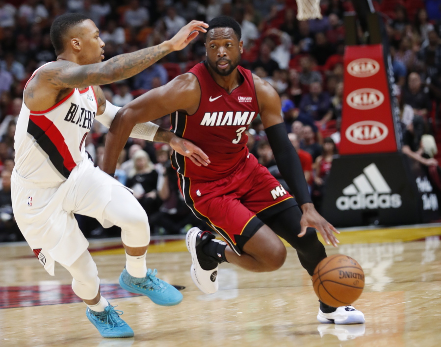 Miami Heat guard Dwyane Wade (3) drives to the basket against Portland Trail Blazers guard Damian Lillard (0) during the first half of an NBA basketball game, Saturday, Oct. 27, 2018, in Miami.
