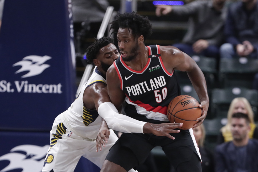 Indiana Pacers guard Tyreke Evans (12) defends Portland Trail Blazers forward Caleb Swanigan (50) during the first half of an NBA basketball game in Indianapolis, Monday, Oct. 29, 2018.
