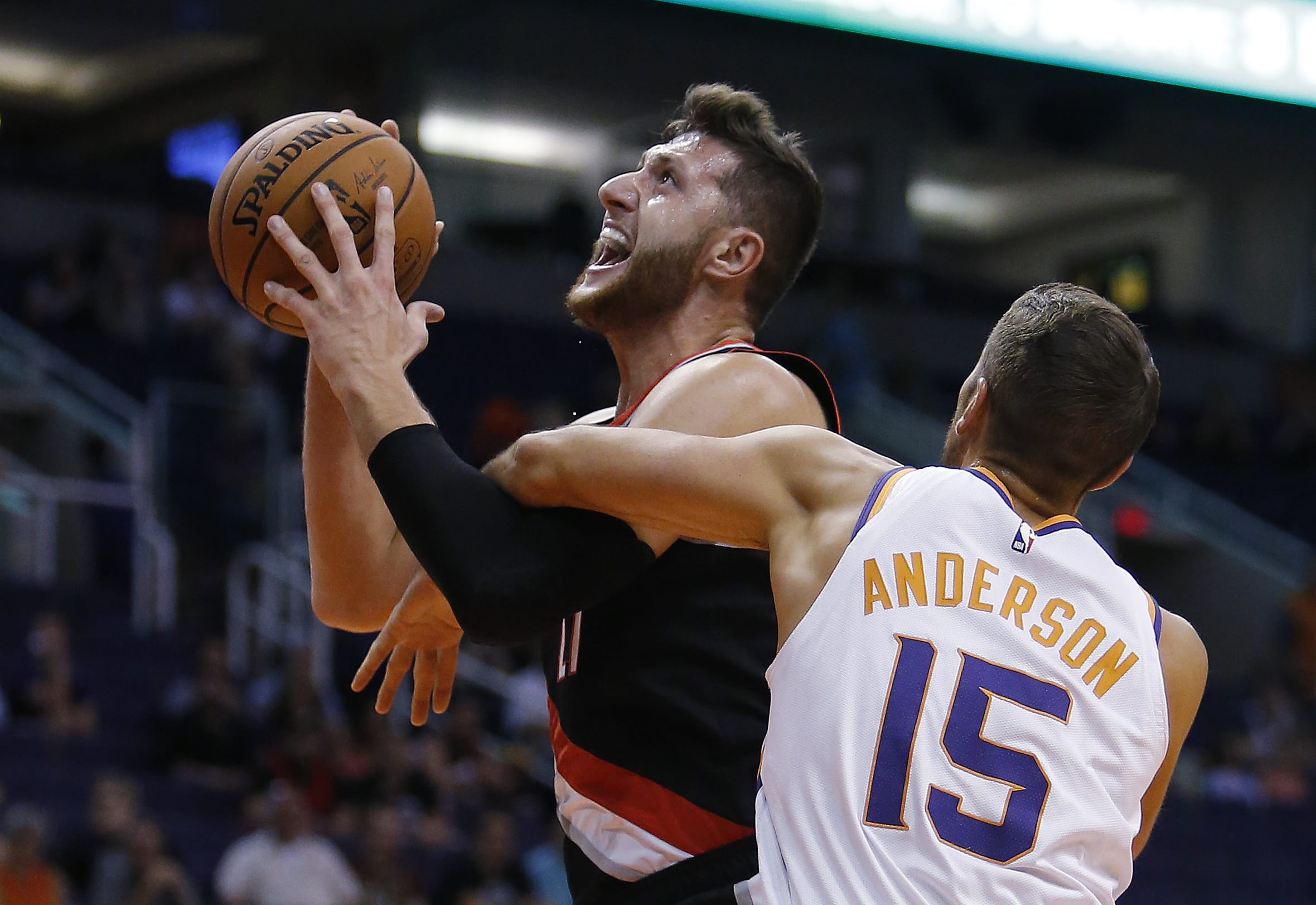 Portland Trail Blazers center Jusuf Nurkic is fouled by Phoenix Suns forward Ryan Anderson (15) during the first half of an NBA preseason basketball game Friday, Oct. 5, 2018, in Phoenix.