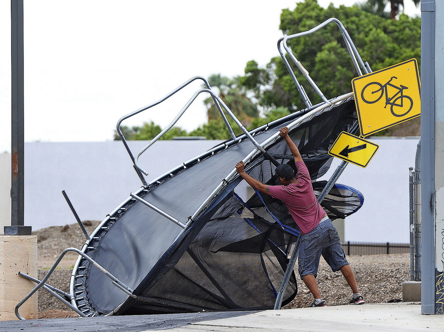 Joel Negrete, 510 S. Avenue A, begins moving a trampoline that was once in his yard before the start of Sunday’s early afternoon rain storm. Tropical Storm Rosa neared Mexico’s Baja California on Monday, spreading heavy rains that were projected to extend into a drenching of the U.S. Southwest.