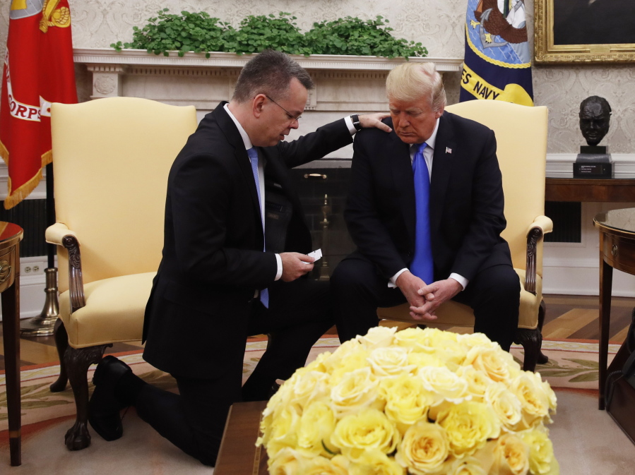 President Donald Trump prays with American pastor Andrew Brunson in the Oval Office of the White House, Saturday October 13, 2018, in Washington. Brunson returned to the U.S. around midday after he was freed Friday, from nearly two years of detention in Turkey.