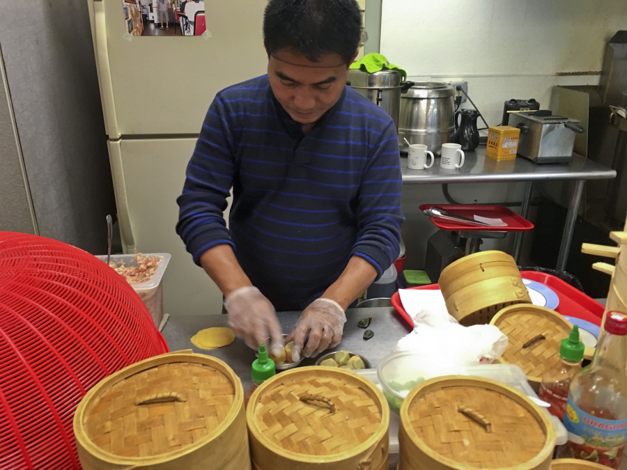 Former Myanmar refugee Maung Maung Saw preps dim sum for lunch trade at the West Side Bazaar, where refugees sell clothes, crafts and food Thursday in Buffalo, N.Y. Thousands of refugees have settled in Buffalo in recent years even as others have left the city. Some locals worry that the Trump administration’s policies reducing the numbers of new arrivals will harm the city’s economy.