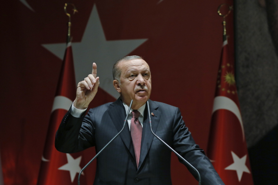 Turkey's President Recep Tayyip Erdogan talks to members of his ruling Justice and Development Party (AKP), in Ankara, Turkey, Friday, Oct. 26, 2018. The Saudi officials who killed journalist Jamal Khashoggi in their Istanbul consulate must reveal the location of his body, Erdogan said Friday in remarks that were sharply critical of the kingdom's handling of the case.