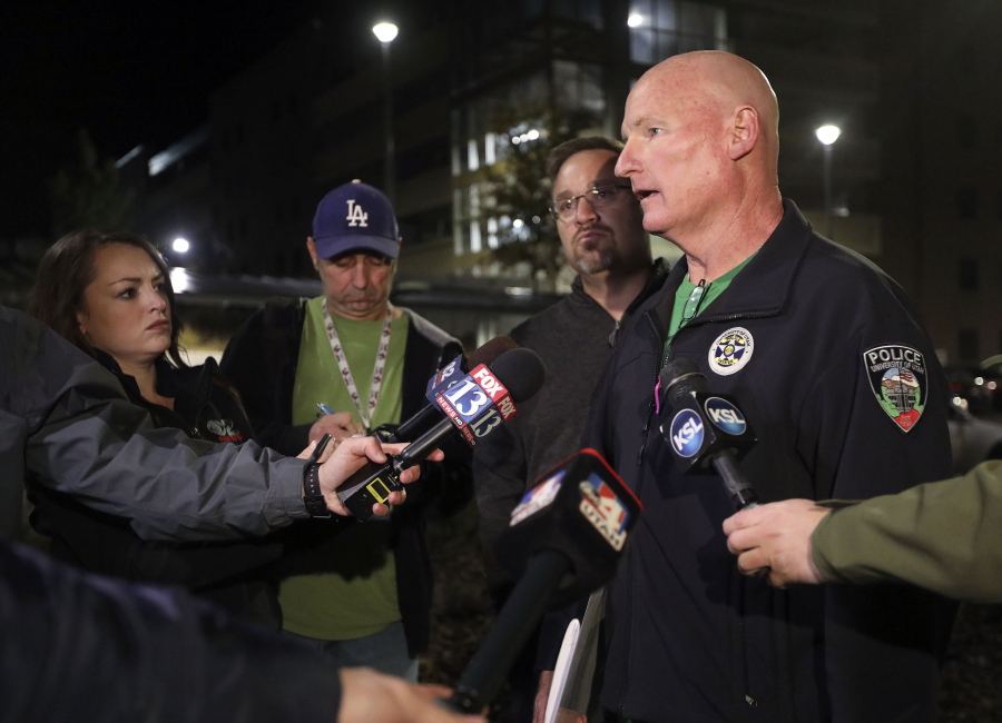 University of Utah Police Lt. Brian Wahlin talks to members of the media outside of the South Medical Tower on the University of Utah campus during a search for a man they say shot and killed a University of Utah student outside of a dormitory on campus, the Salt Lake Tribune reported Monday, Oct. 22, 2018, in Salt Lake City. The female student’s body was found in a car near the medical towers, Wahlin said. The man they are searching for and the student had “a previous relationship,” Wahlin said.