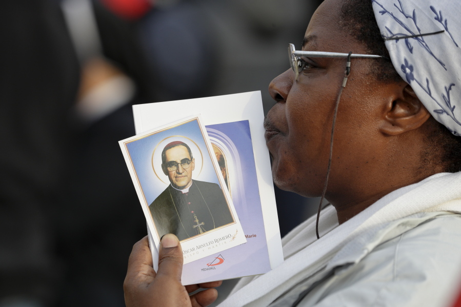 A woman holds a picture of martyred Salvadoran Archbishop Oscar Romero in St. Peter’s Square at the Vatican, Sunday.