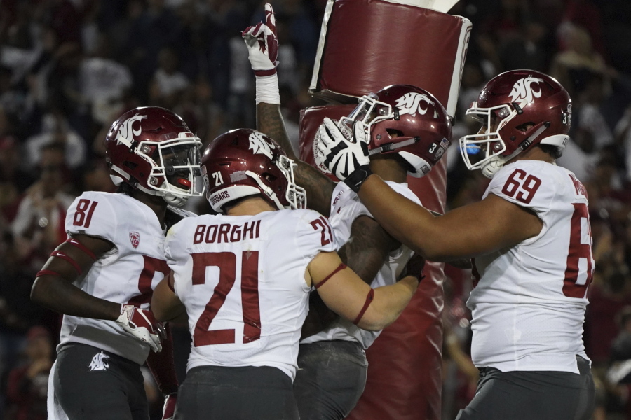 Washington State wide receiver Davontavean Martin, second from right, celebrates a touchdown in the second half against Stanford during an NCAA college football game on Saturday, Oct. 27, 2018, in Stanford, Calif.