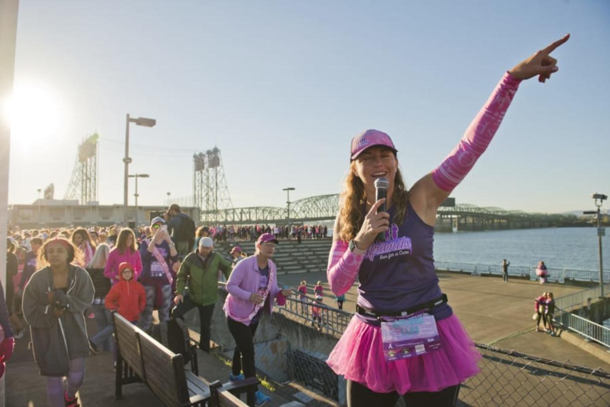 Runners in the 12th annual Girlfriends Run for a Cure race through Vancouver, starting and finishing at WareHouse ’23 at the Vancouver waterfront. Event organizer Sherri McMillan, at center, is seen here leading the runners.