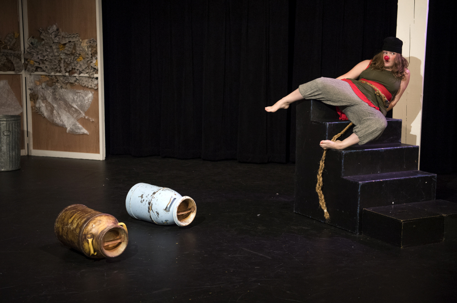 Challenged by a couple of rolling milk cans, Vancouver School of Arts and Academics senior Gracie Martin leaps to safety during dress rehearsal for a theatrical clown play called “This is Not My Home.” (Alisha Jucevic/The Columbian)