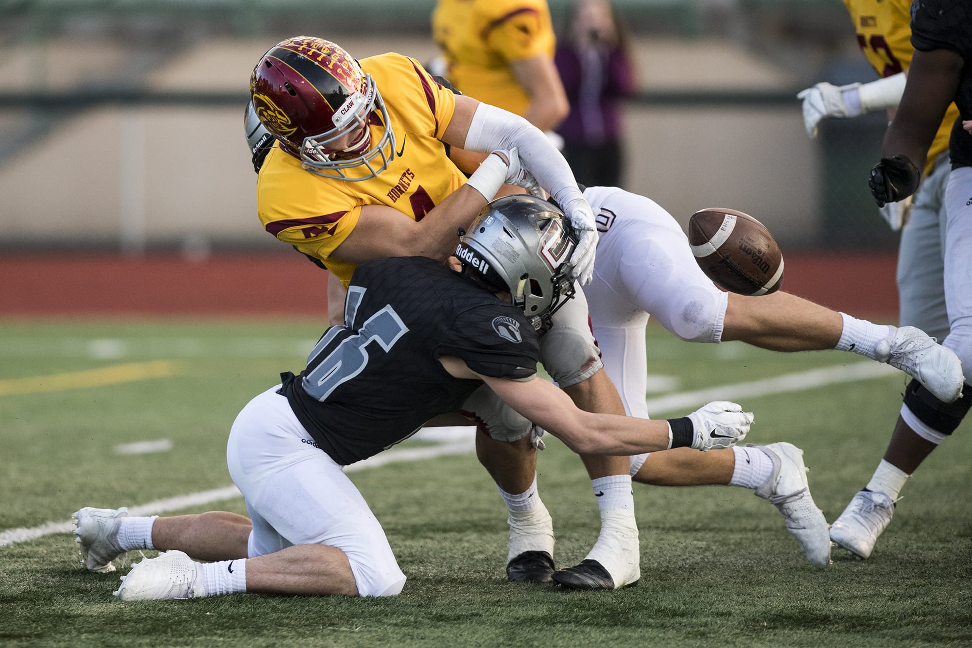 Union's Michael Rogers knocks the ball from the hands of Enumclaw's Ethan Eilertson to force a fumble during a match at McKenzie Stadium Friday night, Nov. 2, 2018.