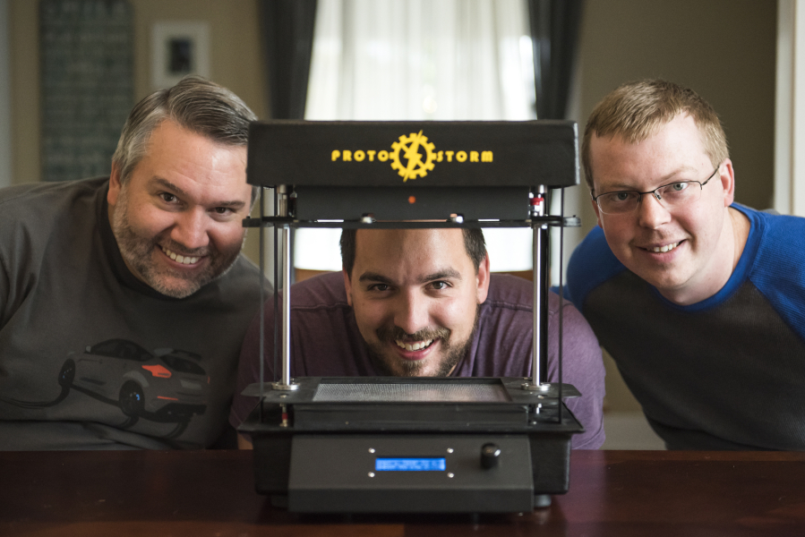 Lorin Mueller, electrical engineer, from left, Chase Harper, supply chain and marketing manager, and Jesse Howard, mechanical engineer, show their prototype desktop thermoformer Friday morning.
