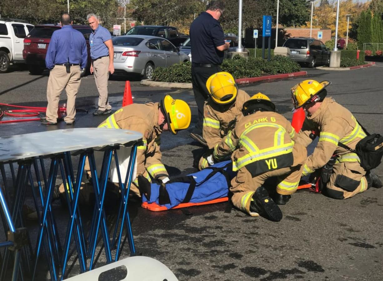 Salmon Creek: Clark County Fire District 6 firefighters help a victim of a 10.4 magnitude earthquake during a training scenario Oct. 18 at Legacy Salmon Creek Medical Center.