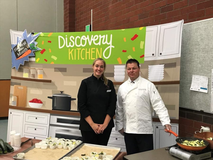 Landover-Sharmel: Sadie Counts, left, food services manager for Endeavour Elementary School, and Chad Kirby, food services production manager, participate in Chartwells Farm to School program, which brought locally grown zucchini to Endeavour.