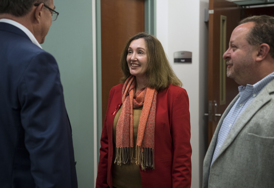 Vancouver City Councilor Laurie Lebowsky talks with community members after the first round of results come in at the Clark County Public Service Center on Tuesday.