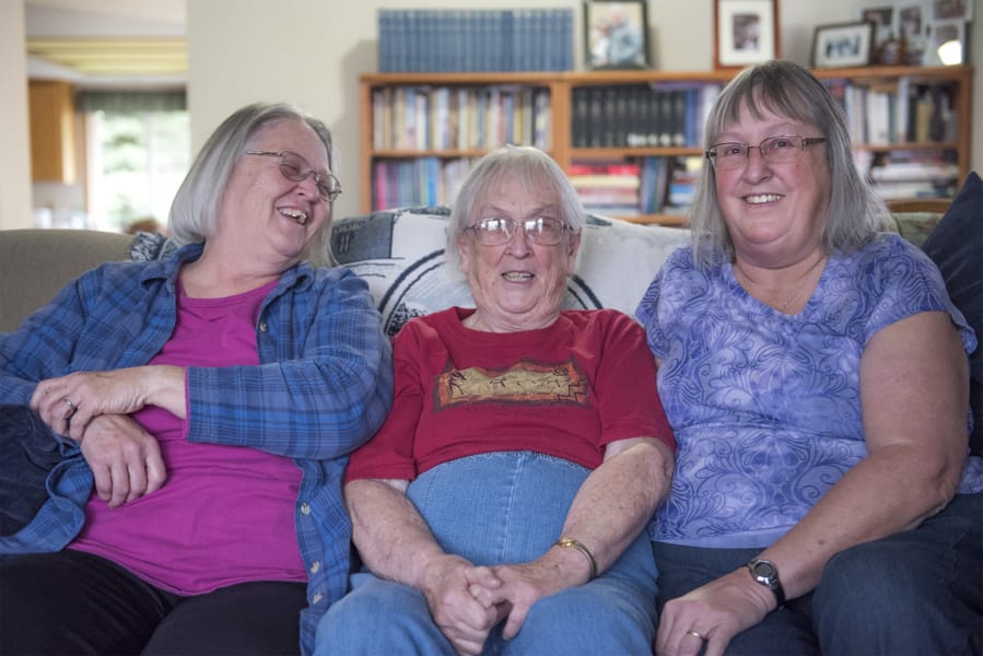 Lethene Parks, center, and her daughters Cathy Sato, left, and Carrie Parks gathered at Lethene’s home in Sifton earlier this month to review their years of research into a pair of murders that haunted their family for nearly two centuries.