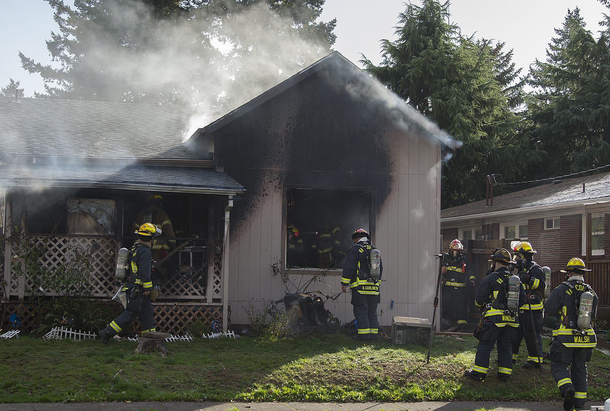 Vancouver firefighters work at the scene of a house fire at 1105 East 29th Street on Friday afternoon, Nov. 2, 2018. One woman was reportedly severely injured in the blaze.