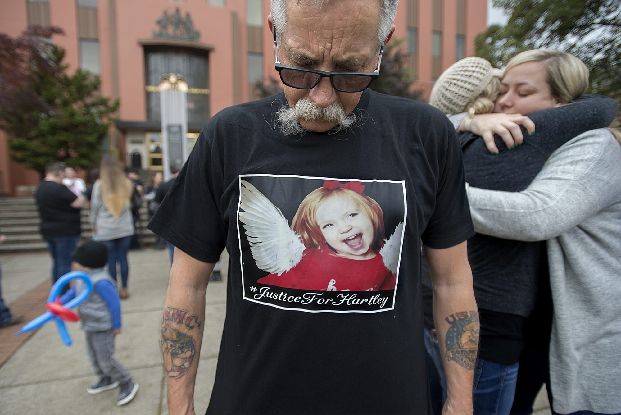Tim Luchau, grandfather of Hartley Anderson, wears a t-shirt in her honor as loved ones gather on the steps at the Clark County Courthouse following the first appearance of Ryan M. Burge on Monday morning, Nov. 5, 2018.