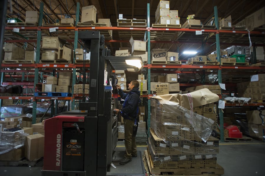 Cesar Hernandez of Price Mart, the warehouse in Portland used by Hi-School Pharmacy, helps distribute stock as he works with colleagues in early November.