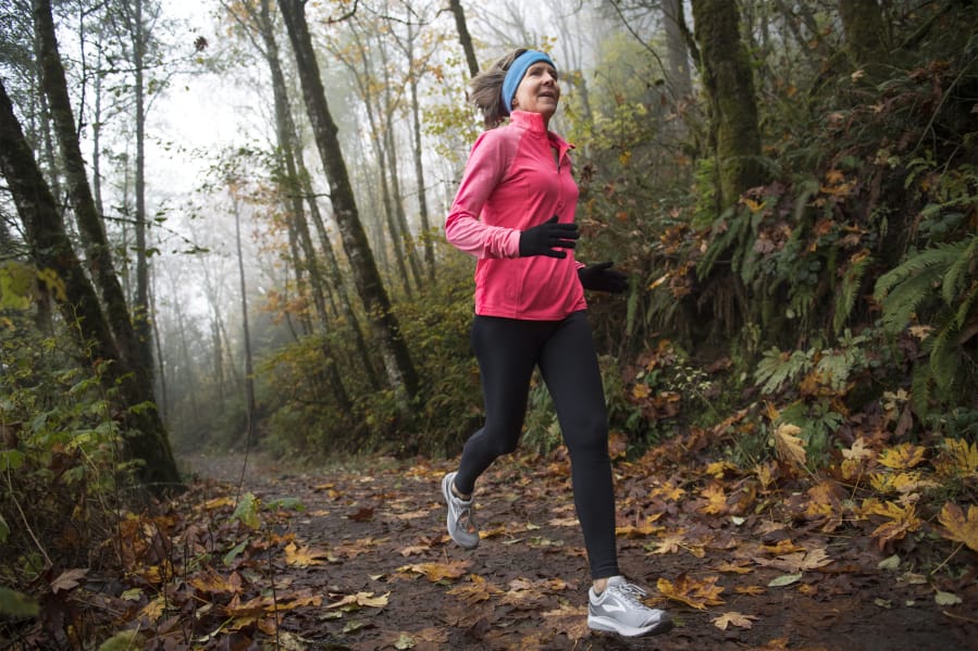 Jane Connell jogs near Lacamas Lake in Camas. Connell will participate in a fundraiser challenge to help her daughter get a track wheelchair. Connell will run or walk 4 miles every four hours for a 48-hour period, starting tonight.