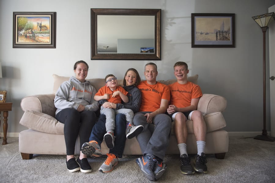 The Snell family, from left, Mackenzie, Micah, Suzie, Jeff and Stephen, pose inside their home in Camas.