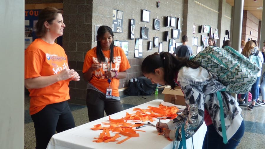 Ridgefield: Ridgefield School District office staff Dani Taylor, left, and Kalin Heath get Ridgefield High School students to pledge their support during National Bullying Prevention Month.
