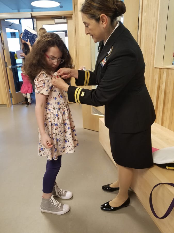 Camas: Navy Lt. Ingrid Rojas attended Lacamas Lake Elementary School’s Veterans Day assembly with Skylar Gregory as a stand-in for her grandfather, a World War II vet who died in 2001.