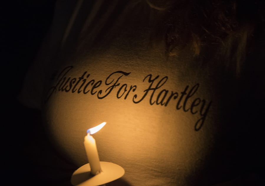 A woman shows her support with her T-shirt during a candlelight vigil in honor of Hartley Anderson, 5, on Friday evening at LeRoy Haagen Memorial Park in Vancouver.