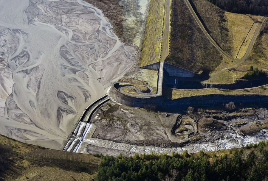 Sediment backs up behind the dam as water flows over the spillway in the bottom left-hand corner of the photo. The Army Corps of Engineers wants to raise the spillway up to 23 feet in future years. (Adam Mosbrucker/U.S.