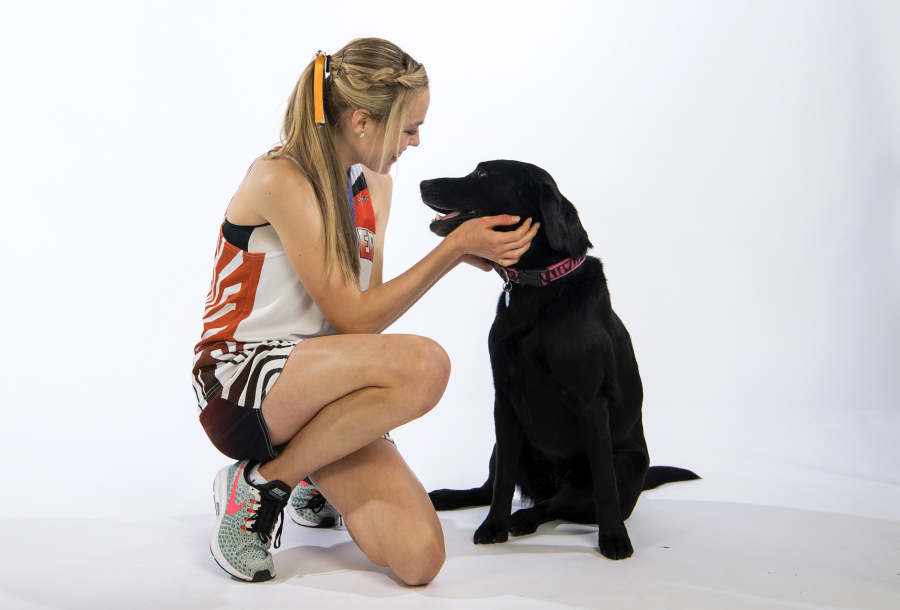 Washougal senior Amelia Pullen, the all-region girls cross country runner of the year, is pictured with her Black Labrador Cienna on Tuesday, Nov. 13, 2018.