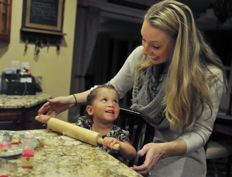 Aliyah and Gwen Bumala prepare for Thanksgiving by baking sugar cookies and treats Tuesday at their home near Washougal. Born to methamphetamine-addicted parents, Aliyah, 2, was adopted out of the foster care system by the Bumalas this summer, making this her first Thanksgiving with the family.