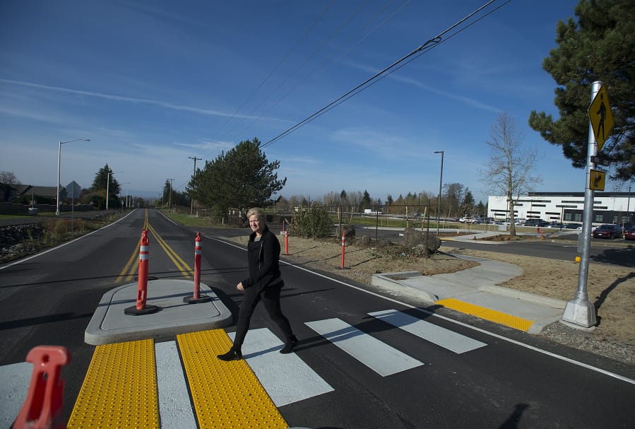 Heidi Rosenberg, director of capital programs for the Camas School District, uses a new crosswalk to cross Northwest 18th Avenue across from Discovery High School in Camas.