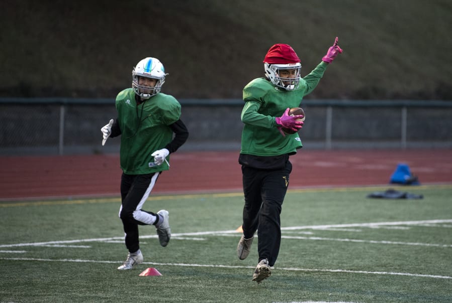 Mountain View’s Michael Bolds, right, runs through defensive drills with his team during practice at McKenzie Stadium. Bolds has a school-record eight interceptions this season.