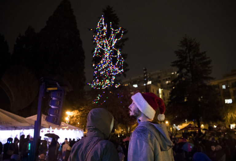 Precious Clark, left, and Kevin Peizner, both of Vancouver enjoy the lights and music during the annual tree lighting ceremony on Friday evening, Nov. 23, 2018, at Esther Short Park in Vancouver. Clark and Peizner said they didn't mind the rain. "It's not going to prevent the festivities," Peizner said.