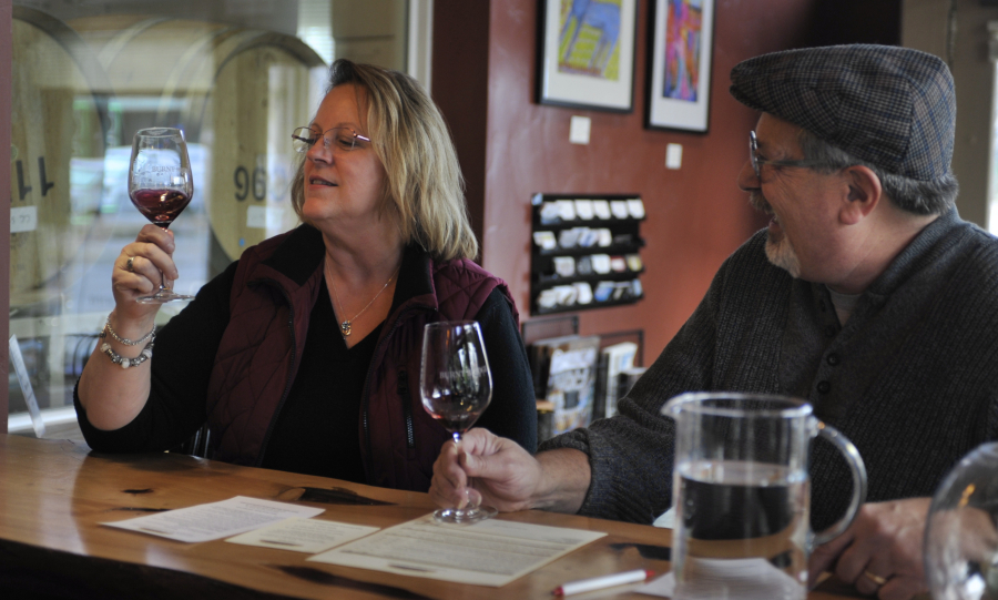 Jeanette, left, and Mike Riopelle savor a newly released wine at Burnt Bridge Cellars in Vancouver on Saturday. The winery particpated in the annual Thanksgiving Barrel Tasting and Fall Release Wines Tour. The event continues today.