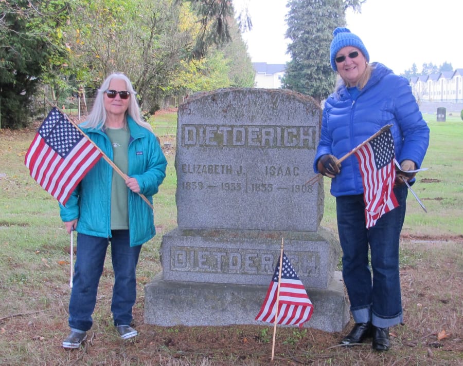 Clark County: Members of the Fort Vancouver chapter of Daughters of the American Revolution, including Cynthia Swanson, left, and Pam Ragan, placed flags on veterans’ graves in honor of Veterans Day.