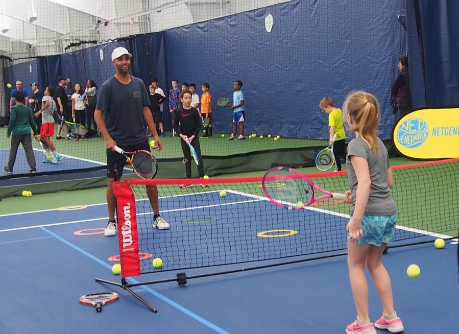 James Blake hit tennis balls with kids during a community event at the Vancouver Tennis Center on Saturday, Nov. 3, 2018.