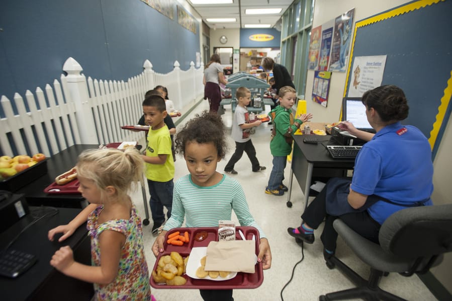 Kindergartners at Pleasant Valley Primary pick up lunch items and pay for their meals in a hallway because the school does not have a cafeteria, as seen on Tuesday morning, Oct. 4, 2016.