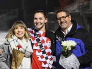 Camas senior Carla Jooste, center, poses with her sister Madison and father Bruce Jooste on senior night.