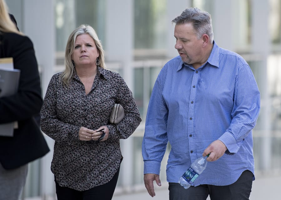 Michelle Bishop, left, estranged wife of former Vancouver pastor John Bishop, right, walk toward James M. Carter and Judith N. Keep United States Courthouse in San Diego, Calif., on Friday afternoon, Sept. 21, 2018.