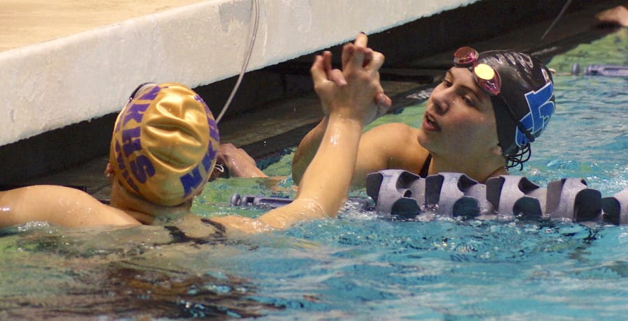 La Center's Hailey Grotte congratulates North Kitsap's Eleanor Beers after Grotte finished second to Beers in the 50-yard freestyle Saturday at the Class 2A state swimming and diving championship at the King County Aquatic Center in Federal Way.