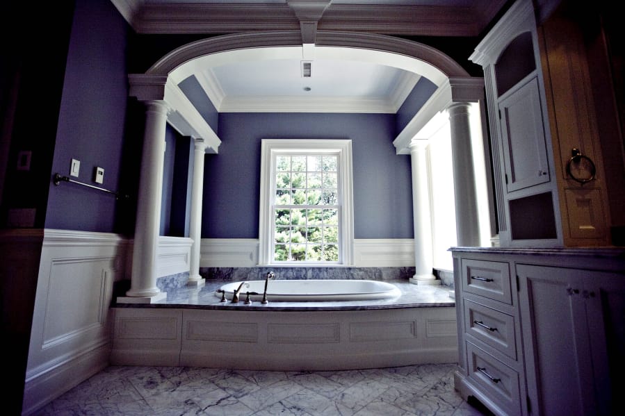 A bathtub below an archway in the master suite bathroom of a multimillion-dollar home in Greenwich, Conn., in 2009. The convenience of a walk-in shower seems to increasingly be winning out over the perceived luxury of a bathtub, some suggest.