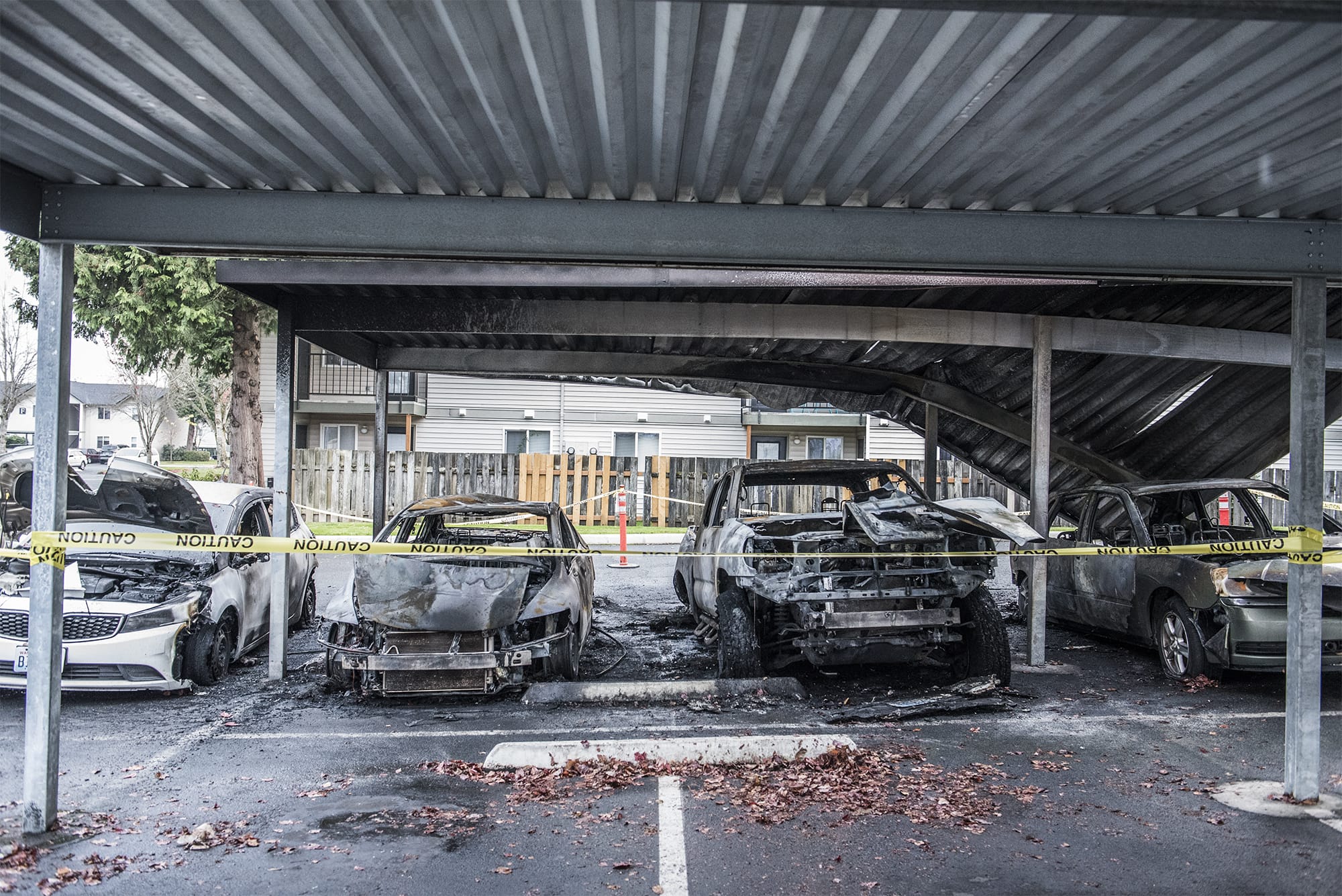 Cars damaged in an early morning car fire are seen here at the Meadow Wood Apartments on Wednesday morning,  Nov. 14, 2018.